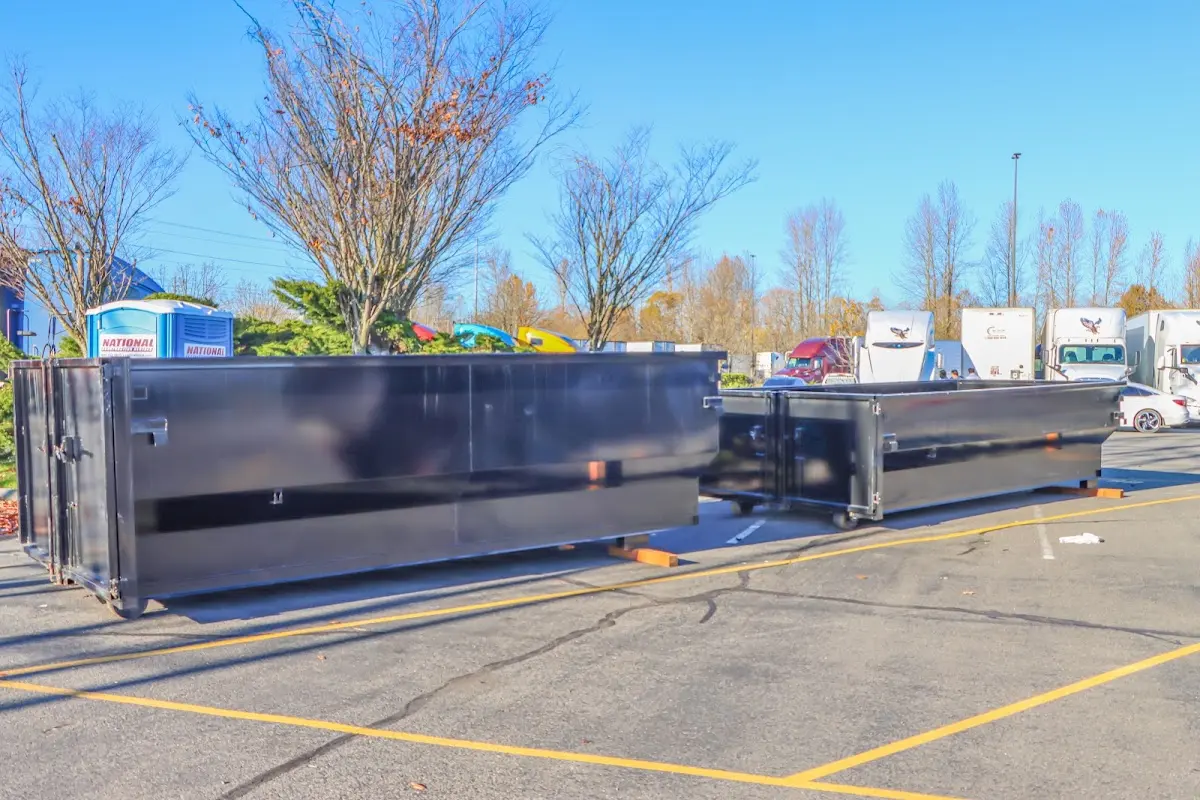 Professional dumpster rental service with roll-off container on residential driveway in Strasburg